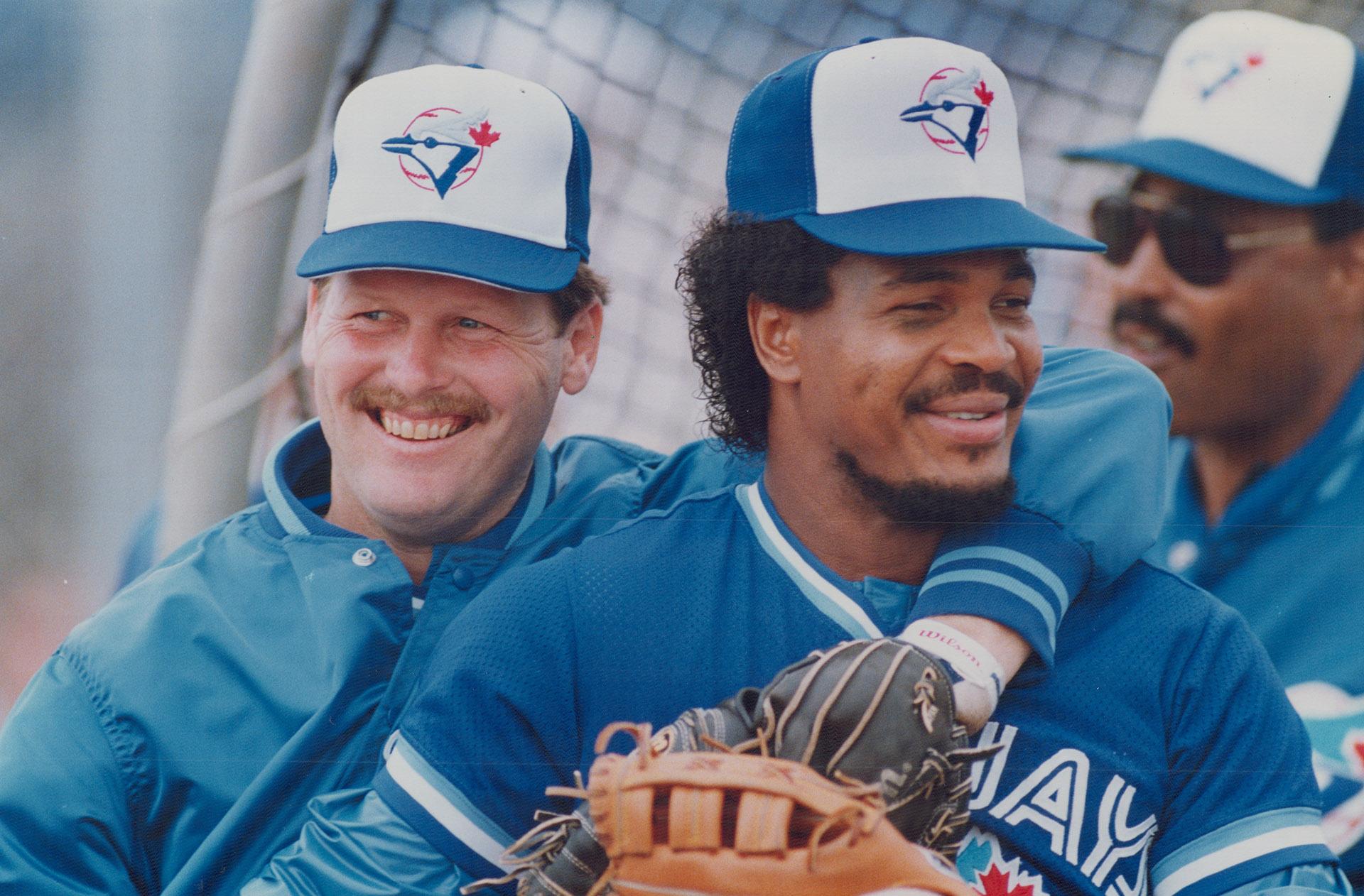Miles of smiles: George Bell, above right, who disrupted spring training  last year with his complaints about being made a designated hitter, and  Ernie Whitt show off the new Blue Jay attitude –