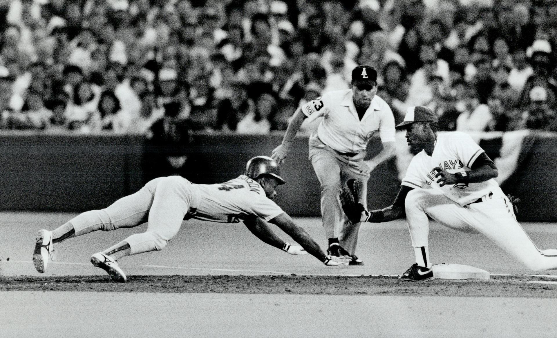 Stretch dive: Oakland's Rickey Henderson desperately reaches for