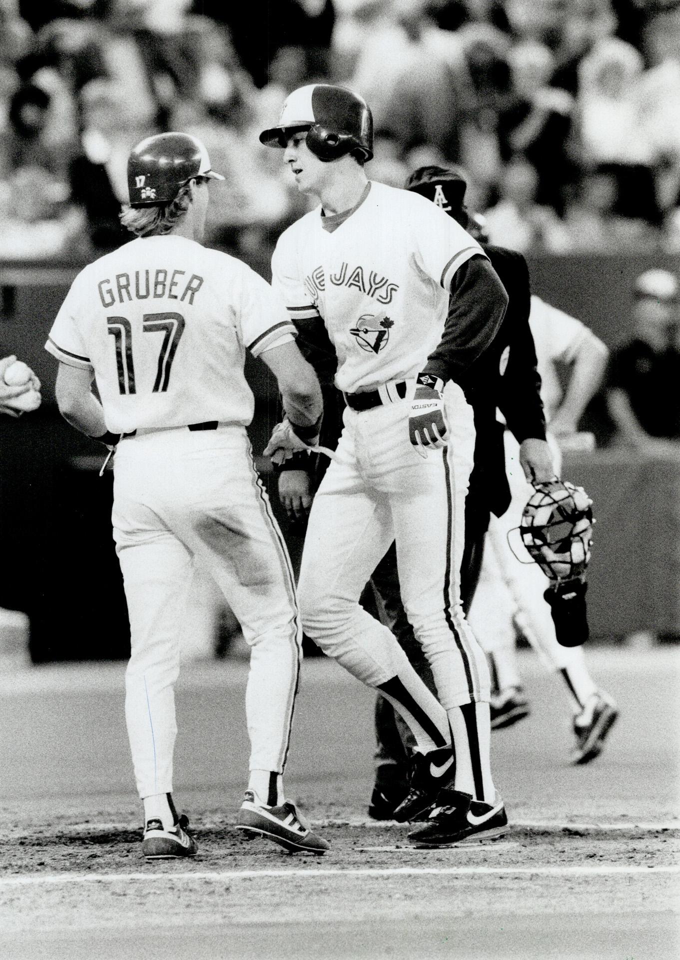 Anything you can do . . . Kelly Gruber, left, had a pair of homers for the  Blue Jays but ex-Jay Cecil Fielder countered with three of his own for the  Tigers