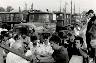Truck drivers talk with Toronto Harbor Commission representatives during protest at the Leslie St