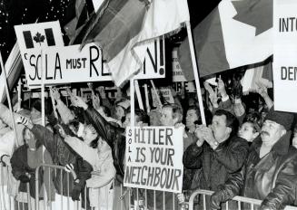 Angry protesters: Waving placards, Canadian and Serbian flags, about 3,000 coverge on Queen's Park last night damanding the resignation of LIberal MPP John Sofa (Mississauga East)
