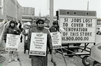 Angry vintage: As guests sip Beaujolals Nouveau wine inside, members of the liqor board workers' Union protest against job cuts outside the renovated LCBO store on Queen's Quay yesterday