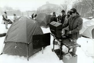 In-tents protest, Rod Marsh starts dinner during a 24-hour campout by about 20 forestry students at the University of Toronto to protest the univerity(...)
