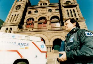 Publicity tour: Paramedic Carmen D'Angelo stands in front of an ambulance with painted credit card logos at Queen's Park yesterday to draw attention to the hazards of privatizing the service