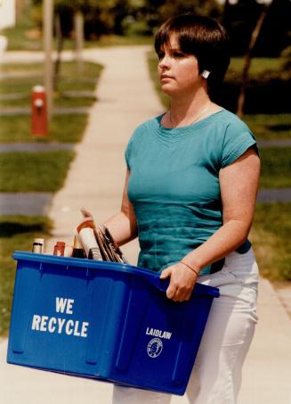 The right stuff: Nancy Gibson of Mississauga carries a blue box with recyclable materials but officials say things have been turning up in the boxes