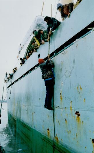 Heading home: A disillusioned Albanian is hauled aboard the ship Tirana as it leaves the port of Brindisi