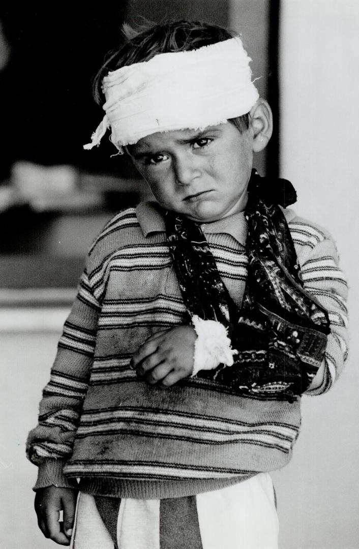 Fleeing death: Kurds, ranging from heavily burdened men to this injured boy, fled Saddam's forces last year