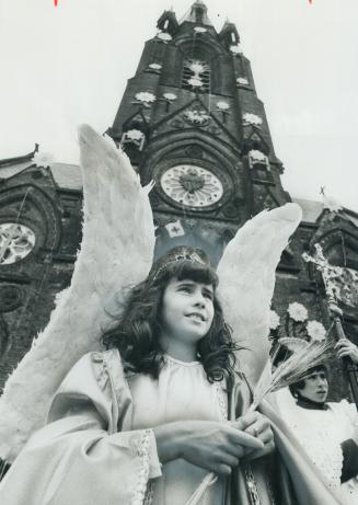 Angel Hermimia Vieira, 10, marches in the hour-long parade from St
