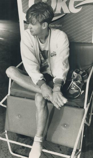Chris Pogson tries to rub some life into his aching feet after hours of pounding the pavement pulling his rickshaw around town