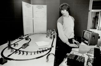 Computer-powered choo-choo, Brian Varga, 17, of Owen Sound Collegiate and Vocational Institute, punches in the power for his computer-controlled hobby(...)