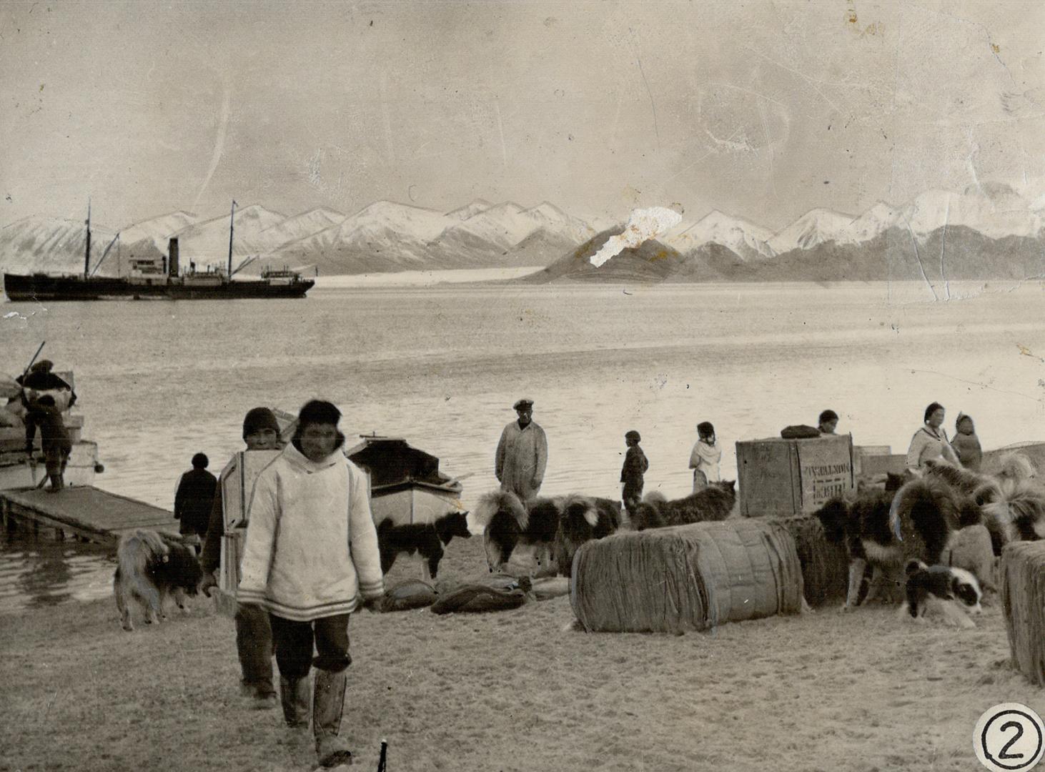 Supplies being landed from the Nascopie which is seen in the left background