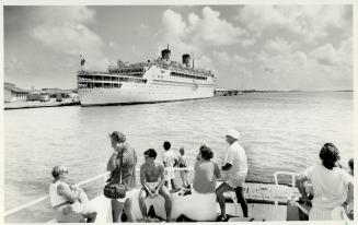 Above, the ship, built to travel the world back in the golden age of liners, is seen at dock in Aruba