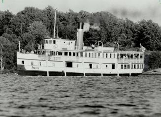 The 96-year-old steamship Segwun, back in cruise service again this summer, sails past typical Muskoka scenery