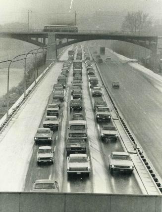 Snarled by the snow, slowly moving lines of cars jam the southbound lanes of the Don Valley Parkway today