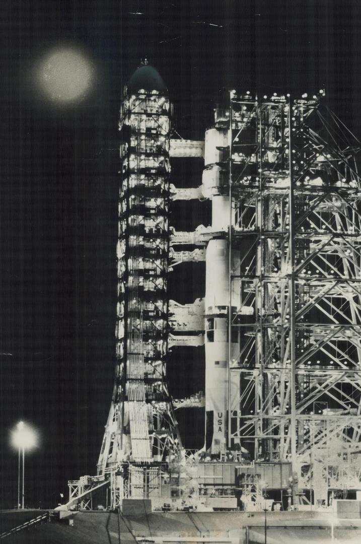 Bathed in Moonlight from the target of its flight, 238,000 miles away, the Apollo 8 mooncraft stands surrounded by its launching equipment on the conc(...)