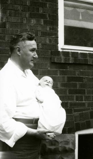 Dr. Ray McCleary and Nansi Elizabeth Anderson. Taken on the day of nansi's christening in the fall of 1947 at the back of their house on Somers Avenue