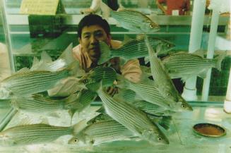 Eng Lam, co-owner of Big Land Farm, is proud of his store's vast seafood department, where the fish is truly fresh