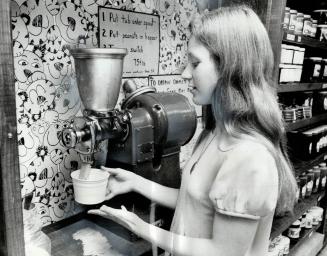 Making her own peanut butter with the help of a grinding machine at Gibson's Natural Foods store on Victoria park Ave