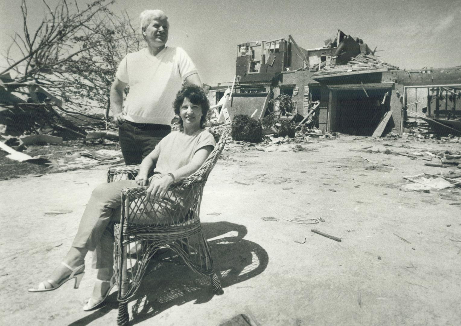 House insured: John and Marion Bayfield of Barrie wait for an insurance adjuster in front of the ruins of their $200,000 home
