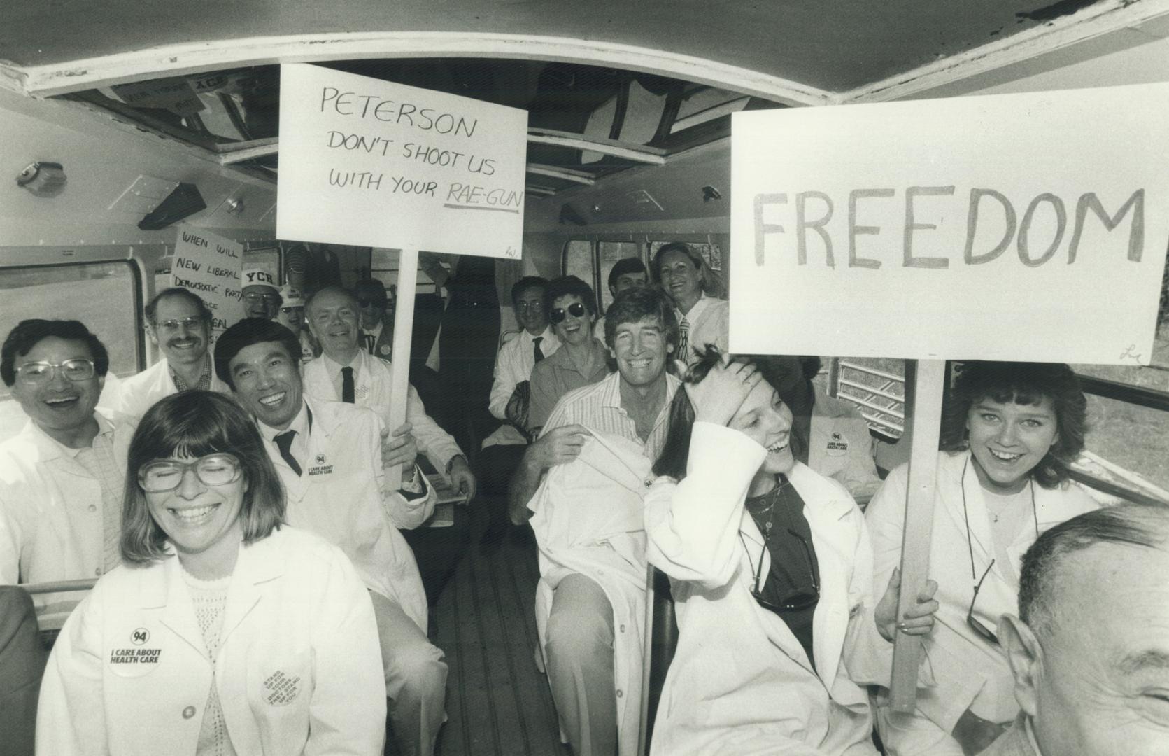Jubilant doctors in white hospital jacket were all smiles today aboard the double-decker bus that carried them from York Central Hospital in Richmond (...)
