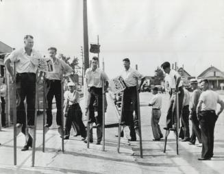 Picketing on stilts is something new for Chrysler workers on strike at Windsor, Ont