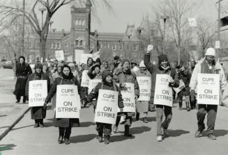 Show of solidarity: Striking workers at the University of Toronto march to Queen's Park from simcoe Hall, then back to the campus where they paraded through the Robarts Library yesterday