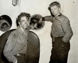 Broken Port Hole outside their living quarters on the Glenelg is inspected by crewmen after the tussle