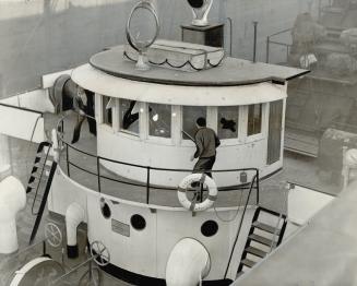 Club-carrying men aboard the coal carrier Glenelg, boarded in the Welland canal at Thorold, are seen outside the wheelhouse. The windows were broken b(...)