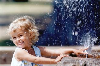 Staying Cool: Kay Leigh Dobbin, 2 1/2, managed to keep her cool on a record-breaking 35C day in June with the help of a water fountain ? and a smile