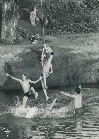 Having A 'swinging' time, The old swimming hole was a great place to be yesterday when the temperature hit the 84-mark