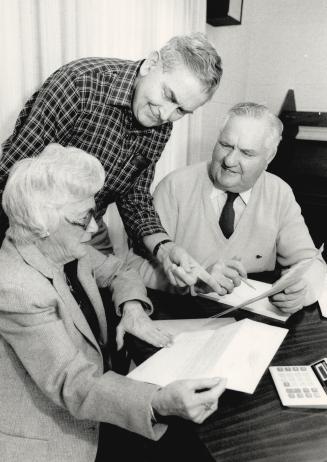 Tax time: Harold O'Brien (centre), one of about 6,000 Revenue Canada volunteers helps seniors like Audrey Garrett and Tom Brandon unravel the mysteries of income tax returns