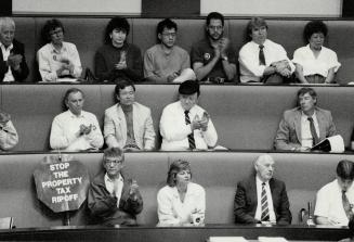 Sombre group: Business people, tenants and homeowners applaud a speaker in the new Metro Hall's council chamber last night