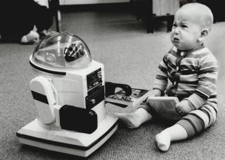 But I don't wanna interface, Noam Lockshin, 9 months, apparently isn't enamored with the music emanating from Omnibot at Armour Heights library
