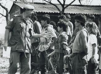 Capt. Graham Newman Inspecting weapens of F.M.L.N. members in Jungles of El Salvador, Near Santa Clara Village
