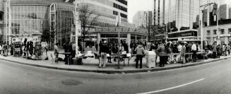 Street vendors crowd the corner of Yonge and Dundas Sts