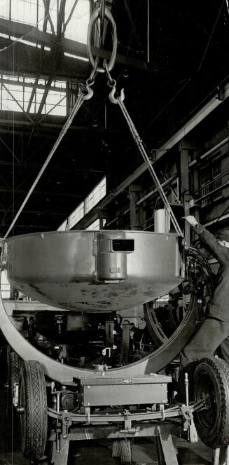 Here is the drum of a searchlight being lowered into what is called the chassis