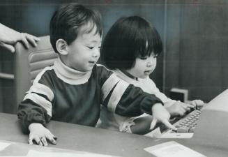 You're my type Oliver Kim, 2, and Emily Nagata, 2 1/2, two of the first Viet Nam refugees to arrive in Toronto, play with a typewriter at Welcome Hous(...)