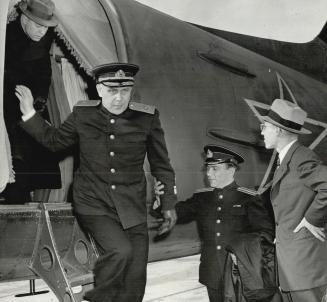 Soviet Rear-Admiral Konstantin Rodionov steps from a plane after a flight from Moscow across Siberia and Alaska