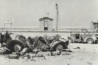 Wreckage of enemy army vehicles strew the ground in front of the Tel el Eisa railway station in the desert-knocked out by the deadly, accurate fire laid down by British gunners in the battle