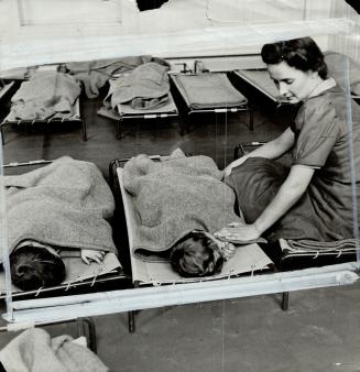 The afternoon siesta at the Garrison Lane school in Birmingham means an after lunch nap in individual cots while a Canadian instructor keeps watch
