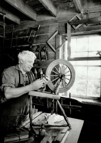 Crafty man: Cabinetmaker and woodcarver Bill Jardine repairs a spinning wheel in his shop at Black Creek Pioneer Village