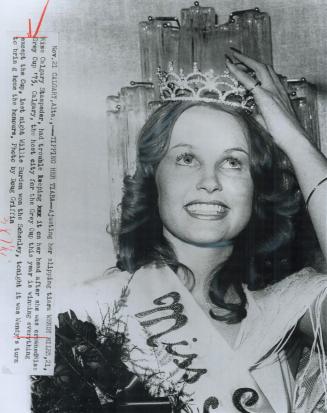 On straight? Wendy Miles straightens her tiara after she was crowned Miss Grey Cup last night in Calgary