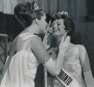 Metro gets a queen, The new Miss Metro Toronto, 20-year-old Marlene Louise Lincoln, gets help from Miss Canada, Linda Douma, in adjusting her crown after winning title