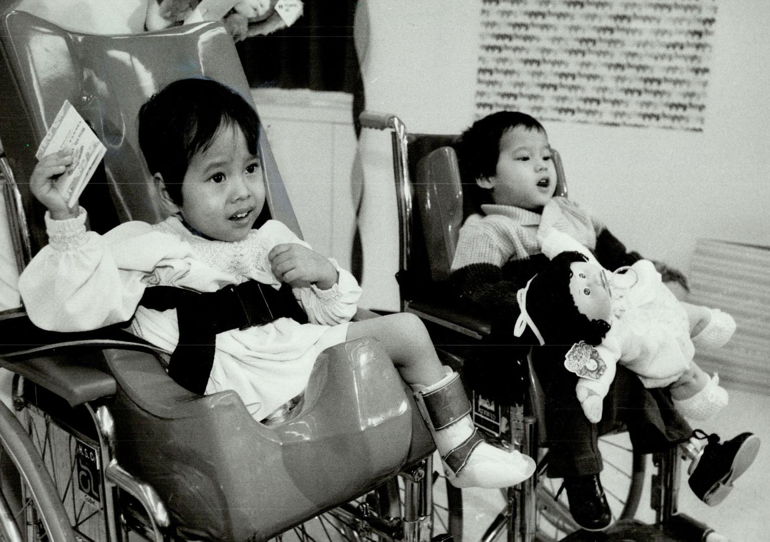 Young twins: Lin Htut, left, goes home Wednesday, and sister Win follows later this year