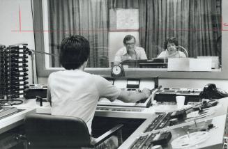 One of about 100 volunteers working for the Radio Reading Service-about 75 of them on-air readers-john Tickell reads news item from The Star along wit(...)