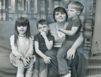 Blind and facing eviction, Agatha Huard, 27, sits with her children in the Ontario Housing Corp