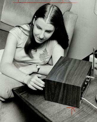 Blind from birth, 16-year-old Janet Gardiner listens to her special receiver she has had for a month