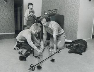 An excellent skier, though blind, Stan King shows his son, Steve, 7, how to prepare his ski equipment