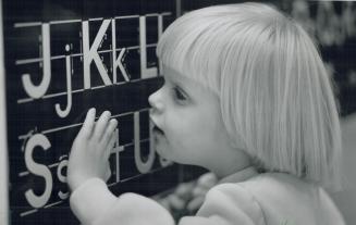 Raised letters help Chelsea Mohler, 4, learn the alphabet, the first step toward learning braille