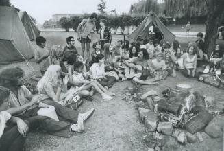 Guttarist Bob Baker entertains blind children enrolled in a summer day camp operated by the Canadian National Institute for the Blind. Tents were up a(...)